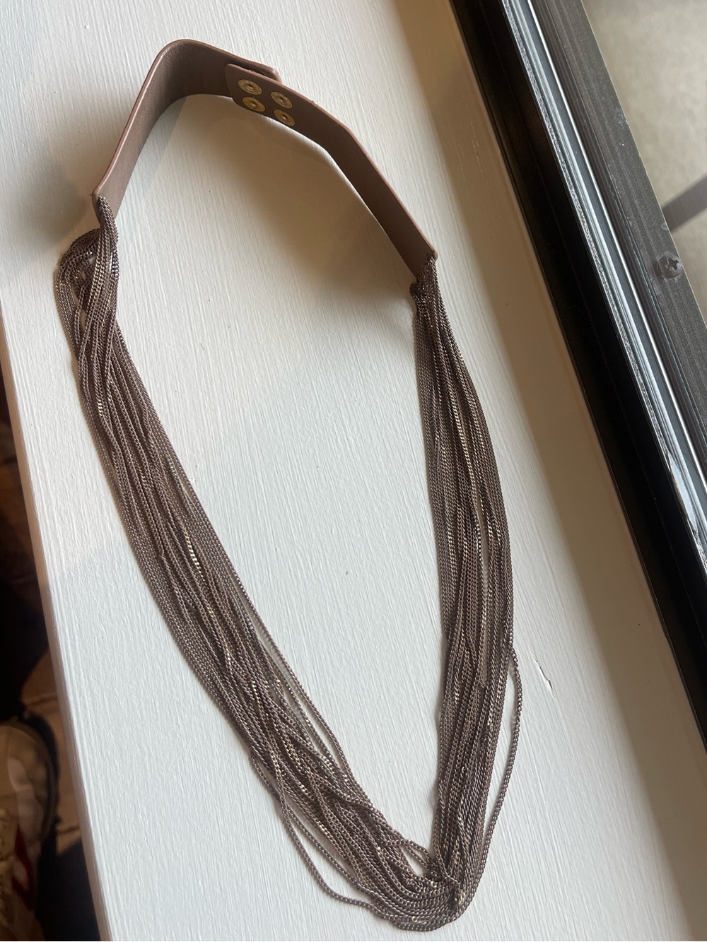 Several strands of chain and leather necklace